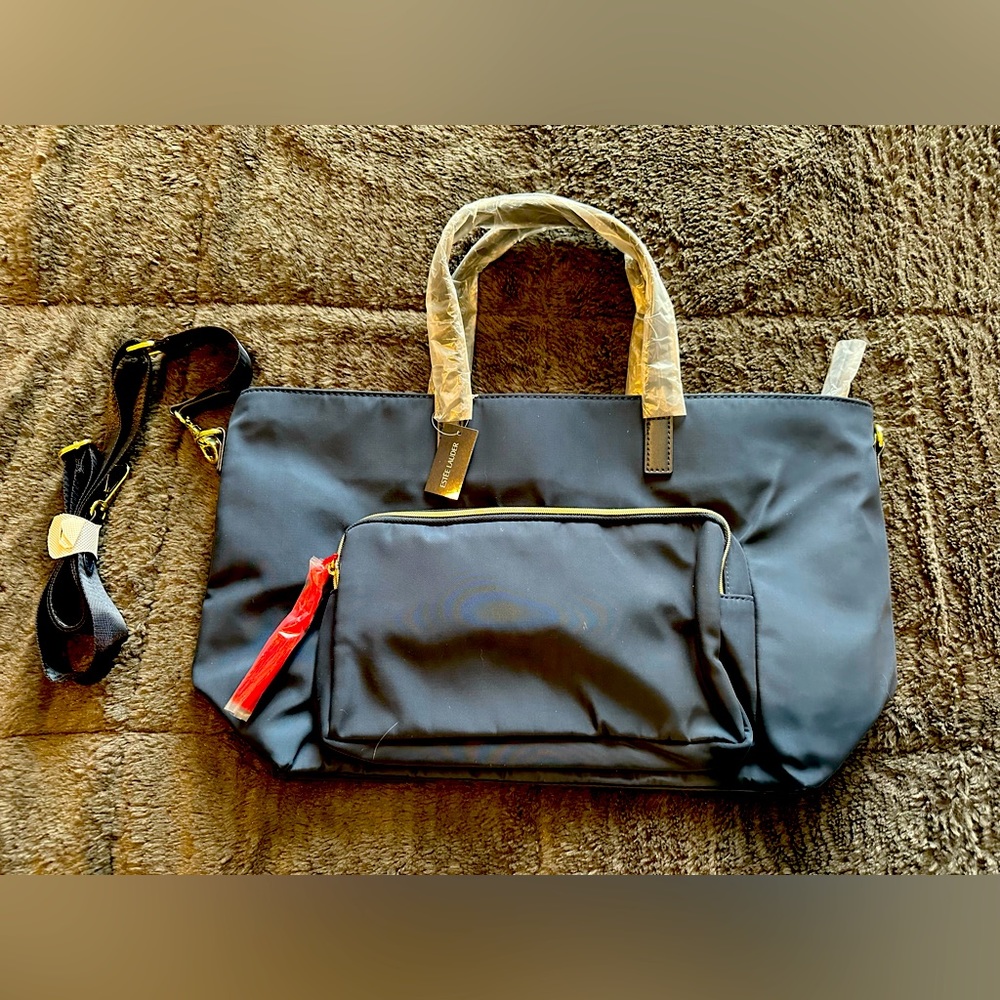 Estée Lauder black bag with red tassel